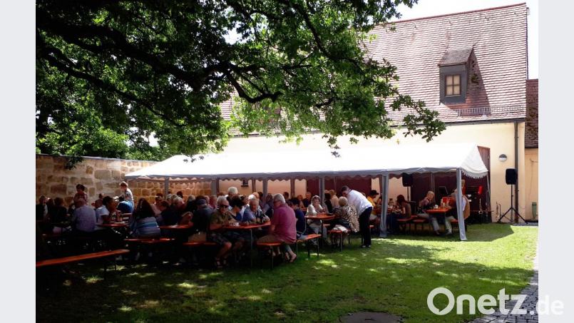 Die Besucher machen es sich im Innenhof des Kastenhauses gemütlich und genießen Zwiebelkuchen, Bratwürste und Steaks vom Grill. Bild: abu