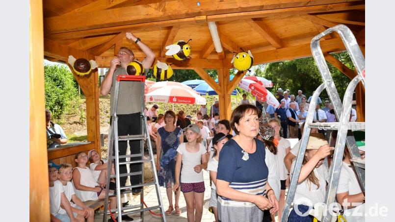 Den Abschluss des Eröffnungsprogramms markiert ein Aufhängen vieler Bienen-Maskottchen unterm Dach des neuen Funktionsgebäudes durch Bauhofleiter Johannes Grötsch (links) und Gertie Kreuzer (rechts). Bild: fjo