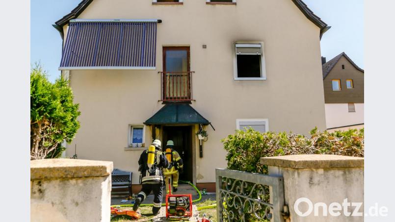 Feuerwehrleute dringen unter Atemschutz in das Gebäude an der Schillerstraße vor. Bild: Hösamer