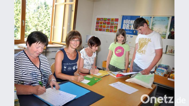 Trotz rekordverdächtiger Hitzegrade am Donnerstag fanden Korbinian Seegerer mit seiner Schwester den Weg in die Gemeindebücherei, die seit einiger Zeit von Charlotte Frey und Monika Haberl (von rechts) geleitet wird. Anna Götz (links) stellt sich für die Ausleihzeit am Donnerstag von 17 bis 18 Uhr zur Verfügung. Bild: es