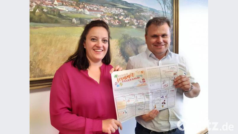 Bürgermeister Karlheinz Budnik dankt Katja Stessmann für die Gestaltung des Ferienprogramm-Flyers. Bild: Lowak