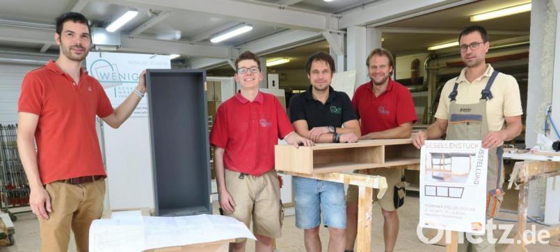 Lehrling Johannes Graf (Zweiter von links) hat als Gesellenstück ein Telefon-Sideboard gefertigt. Obermeister Fabian Kraus, die Ausbilder Christian und Martin Weniger, und Vorstandsmitglied Michael Bräu (von links) werben für die Ausstellung der Gesellenstücke am Sonntag im Oberpfälzer Künstlerhaus. Bild: Hirsch
