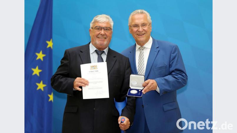 Innenminister Joachim Herrmann (rechts) überreichte am Montag die Kommunale Verdienstmedaille in Silber an den ehemaligen Reuther Bürgermeister Josef Zölch. Bild: Sammy Minkoff