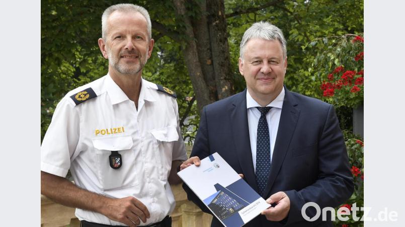 Landrat Richard Reisinger (rechts) hält den Sicherheitsbericht in den Händen, den ihn Polizeivizepräsident Thomas Schöniger überreichte. Bild: Petra Hartl
