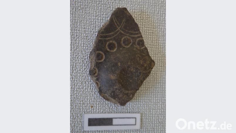 Eine Scherbe von der Wand eines kleinen Gefäßes mit für die Frühlatenezeit typischen Verzierungen in Form von Kreisstempeln und sich überschneidenden Bogenfriesen. Bild: exb/Engelhardt