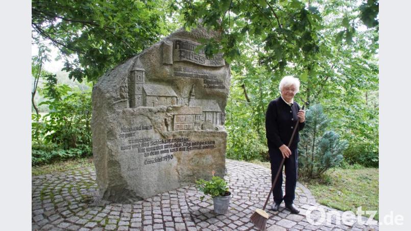 Anna Preßl bei Säuberungsarbeiten am Gedenkstein in Friedrichshäng. Dieser erinnert an die ehemaligen Orte Plöß, Wenzelsdorf, Rappauf, Straßhütte, Dorfmühle und Zankmühle. Bild: mmj