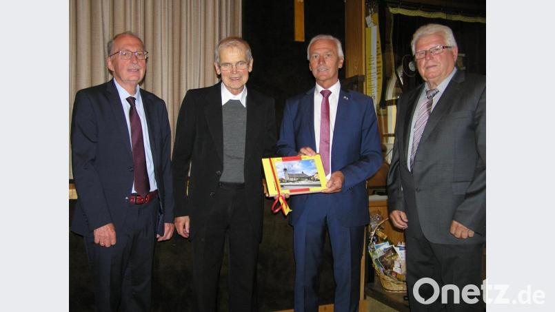 Erster Bürgermeister Peter König (Zweiter von rechts) über gab bei der Verabschiedung von Pfarrer Hans Riedl (Zweiter von links) ein Fotobuch von Neusorg. Mit im Bild: Zweiter Bürgermeister Dr. Günther Fütterer (links) und dritter Bürgermeister Richard Stock (rechts). Bild: öt