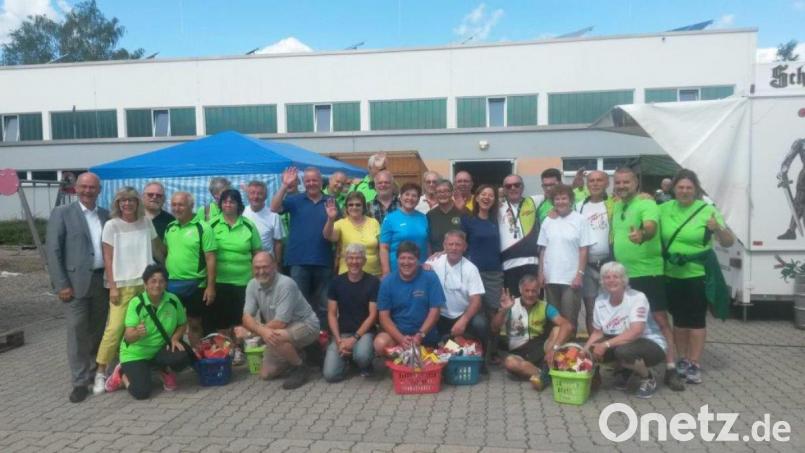 Der Wanderwart des Grafenwöhrer Wandervereins, Alfons Dobmann (knieend, Vierter von rechts), nimmt einen großen Geschenkkorb für den zweiten Platz entgegen. Bild: myd