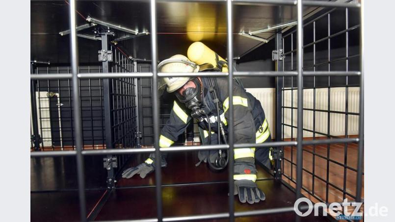 Geübt wird in miteinander verbundenen Gitterkäfigen, und das ist ganz schön schwer: Schon der Pressluftatmer, den sich die Aktiven umschnallen, wiegt in der Regel 15 Kilo. Bild: exb