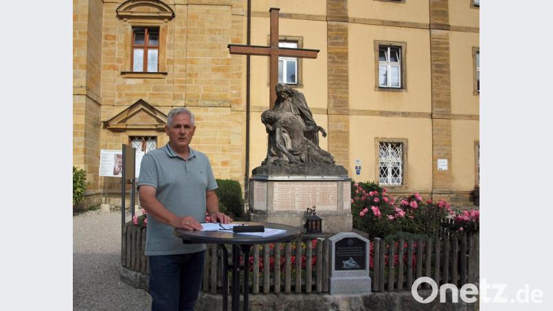 Das Kriegerdenkmal (im Hintergrund) solle Ort der Erinnerung und Mahnung sein „und fordert jeden Betrachter auf, sich mit den historischen Geschehnissen kritisch auseinanderzusetzen“, so Johann Weiß bei seiner Einführung in die Ausstellung. Bild: sön