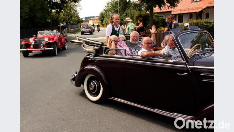Ausgiebig genießen die Gäste die Rundfahrt im Oldtimer durch den Ort. Bild: zer