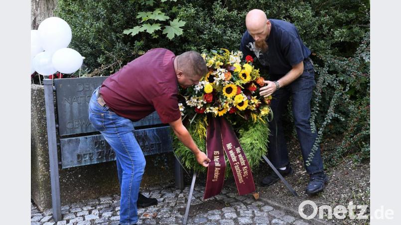 In Erinnerung an die Kriegsopfer legen der stellvertretende Betriebsratsvorsitzende Martin Heiß (links) und der IG Metall-Vertrauensmann Tadeusz Przerwa-Tetmajer einen Kranz nieder. Bild: Petra Hartl