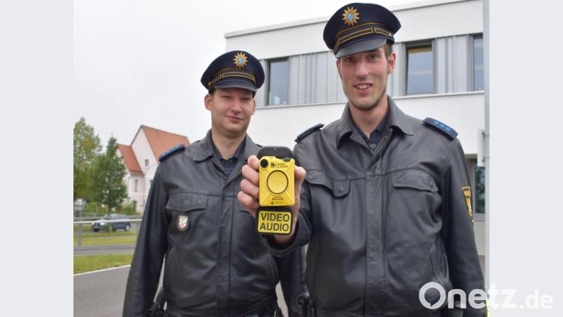 Polizeihauptmeister Markus Jobst und Polizeiobermeister Florian Riedl (von links) präsentieren die Body-Cam als neues Einsatzmittel der Polizieiinspektion Tirschenreuth. Bild: szl