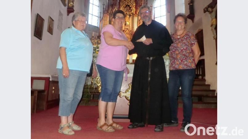 Marga Kukla, Andrea Zeitler (von links) und Zilla Wöhr (rechts) überreichten 200 Euro an Pfarrer Götz für seine Missionsarbeit. Bild: rpp