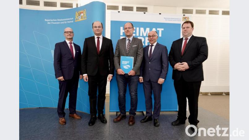 Schwarzenbachs Bürgermeister Thorsten Hallmann (Mitte) darf mit stellvertretendem Landrat Albert Nickl (Zweiter von rechts) die Auszeichnung &quot;Gütesiegel Heimatdorf&quot; von Finanzminister Albert Füracker (Zweiter von links) entgegennehmen. Bild: Bayerisches Staatsministerium der Finanzen und für Heimat/Christian Blaschka