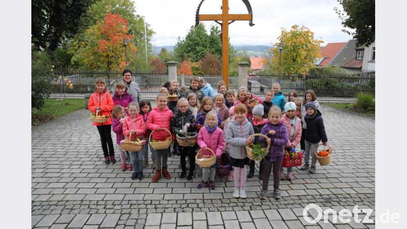 Zusammen mit Gemeindereferentin Roswitha Heining (hinten links) brachten die Kinder ihre Erntedankgaben in Körbchen mit zum Familiengottesdienst. Bild: njn