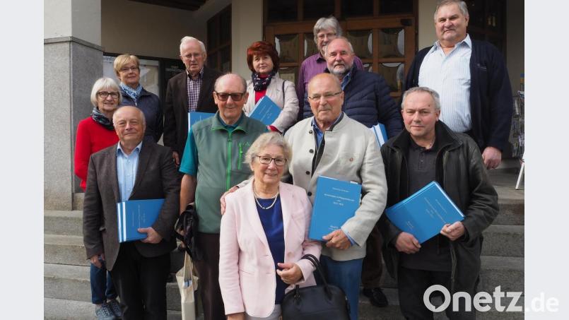 Max Zinnbauer (vorne, Zweiter von rechts, mit seiner Frau Ellen) hat sein Lebenswerk weitgehend unter Dach und Fach: Zusammen mit den Mitstreitern (vorne von links) Willibald Wirnshofer und Paul Wallinger sowie Reiner Reisinger (vorne rechts), weiteren Helfern und Interessierten sowie stellvertretender Bürgermeisterin Christa Zapf präsentierte er Band 15 und 16 der "Blauen Reihe". Bild: bl