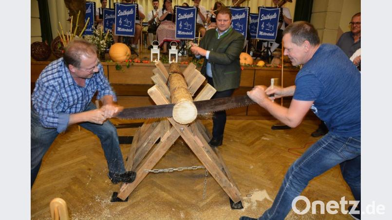 Hubert Sommer (links) und Roland Hildebrand waren die klaren Sieger des Baumstamm-Sägewettbewerbs. Hinten im Bild Zweiter Bürgermeister Stefan Grillmeier. Bild: jr