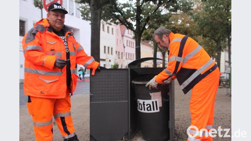 Marcus Drechsler hat den Dreikantschlüssel gezückt, der die Mülleimer in der Weidener Altstadt öffnet. Er ist wie Johann Nickl (rechts) fast jeden Tag auf der Jagd nach Müll unterwegs durch die Stadt. Bild: olr