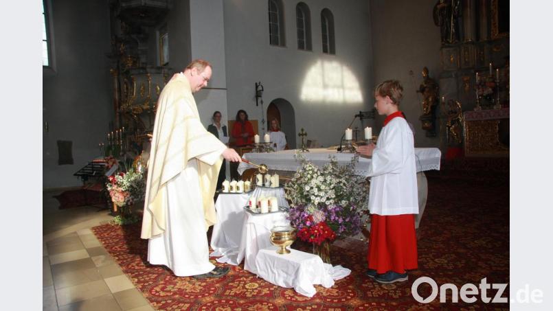 Für jedes Jubelpaar wurde von Pfarrer Markus Nees eine Kerze gesegnet. Von den Ministranten wurden sie anschließend entzündet. rt. Bild: wro