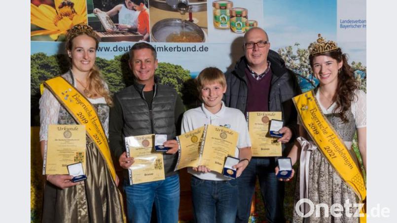 Von der Honigprinzessin Alexandra Krumbachner (links) und der Honigkönigin Katharina Gegg (rechts) eingerahmt, präsentieren die Honigpreisträger (von links) Frank Pamler, Jannik Bohmann und Alexander Titz ihre Urkunden und Medaillen. Bild: (C)STK