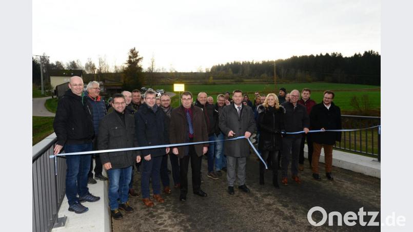 Nach den Ansprachen und der Segnung der Brücke durchschneiden Bürgermeister Rainer Rewitzer und zweite Bürgermeisterin Andrea Lang das weiß-blaue Band. Bild: bey