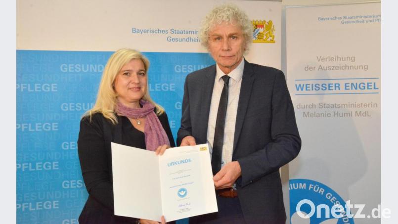 Landrat Wolfgang Lippert nahm die Auszeichnung stellvertretend für Irene Komarek von Ministerin Melanie Huml entgegen. Bild: Landratsamt Tirschenreuth/exb