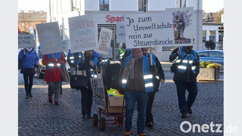 Einen Großteil ihrer Protestschilder mussten sie am Bahnhof zurücklassen.Nur ein Häufchen Demonstranten zieht in Weiden gegen eine CO2-Steuer zu Felde. Bild: Kunz