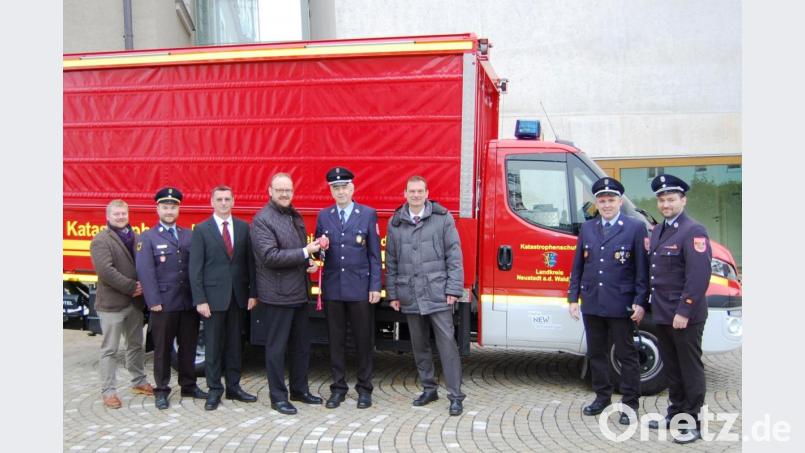Landrat Andreas Meier (Vierter von links) übergibt an den Altenstädter Feuerwehr-Kommandanten Gottfried Amschl (Vierter von rechts) den Fahrzeugschlüssel für den Katastrophenschutz-Gerätewagen-Logistik (GW-L). Bild: sm