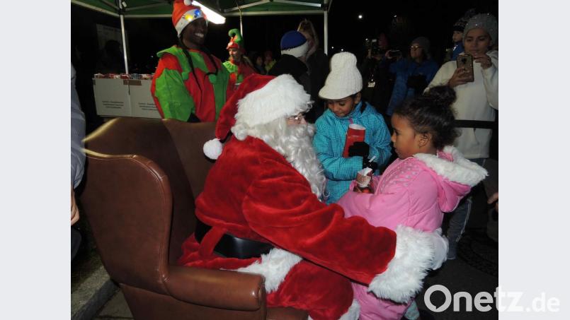 Über Päckchen des DAGA und ein Foto mit Santa und dem Nikolaus freuen sich die Kinder. Bild: mor