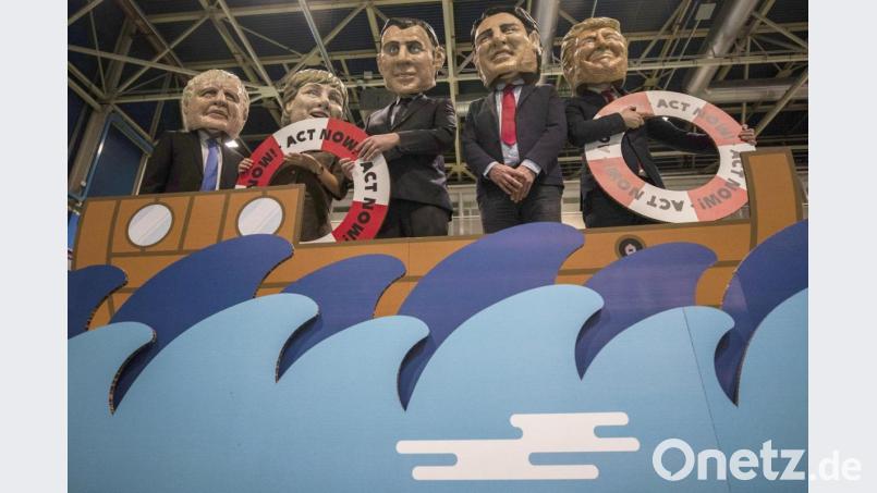 Aktivisten von Oxfam International, die auf der UN-Klimakonferenz in Madrid den britischen Premierminister Johnson, Bundeskanzlerin Merkel, den französischen Präsidenten Macron, den kanadischen Premierminister Trudeau und US-Präsident Trump (von links) darstellen. Bild: Bernat Armangue/dpa