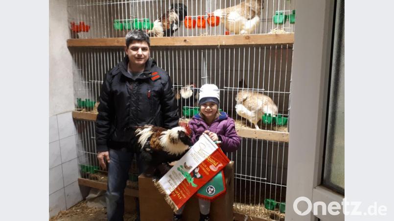 Stefan Weiß mit Tochter und Jungzüchterin Johanna und dem Junghahn "Fritz", der der Beste in seiner Klasse war. Bild: ct