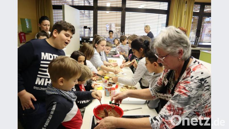 Beim Plätzchenbacken mit dem Frauenbund Neuhaus wurden zusammen mit den Kindern der Offenen Ganztagsschule 5,5 kg Teig zu Butterplätzchen und Engelsaugen verarbeitet. Bild: wrm