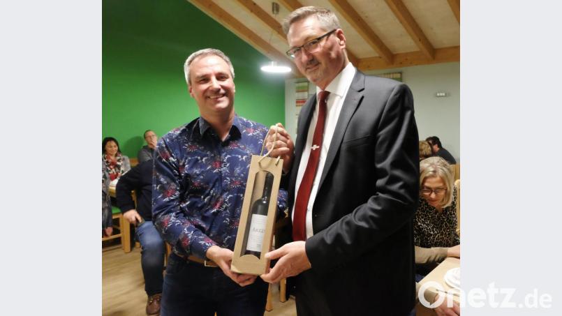 Stellvertreter Thomas Rohrwild (links) überreichte Bürgermeister Hans Prechtl als symbolische Geschenk eine Flasche Wein. Bild: ohr