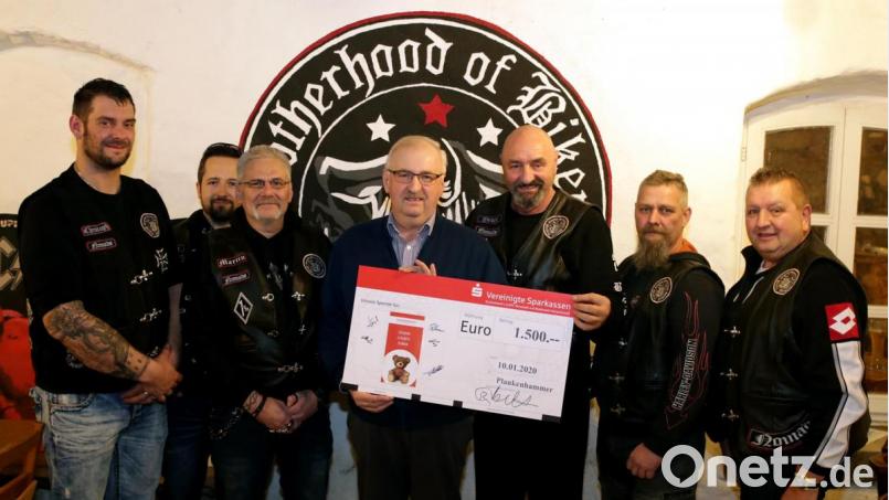 Herbert Putzer (Mitte)erhielt einen symbolischen Scheck über 1500 Euro für krebskranke Kinder aus den Händen des Stammtischs „Brotherhood of Bikers Naabtal Nomads“. Bild: mef