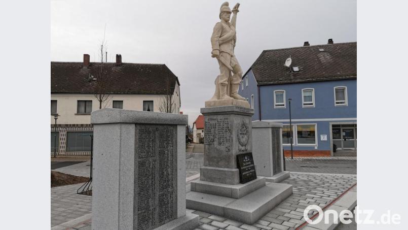 Der Vorsitzende des Kriegervereins Albert Grießl wies auf die dunklen Flecken am Sockel des Denkmals hin. Bild: gz