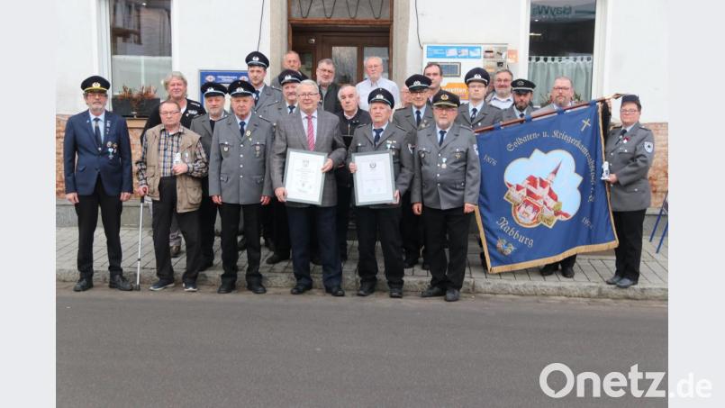 Stolz präsentieren die Geehrten ihre Urkunden und die Vereinsmitglieder die neue Fahne. Bild: ral