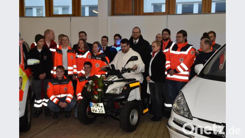 Pater Johannes Bosco und Landrat Andreas Meier, der auch stellvertretender BRK-Kreisverbands-Vorsitzender ist, nehmen auf dem Quad der Rotkreuzbereitschaft Platz. Bild: hcz