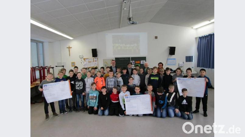 Die Schüler der 5. Klassen sowie Studiendirektor Stephan Drexler (hinten links) überreichten an Annemarie Schraml, Geroldine Ondrusek und Edith Lippert (von links) nach den Präsentationen der Hilfswerke die Schecks. Bild: ubb