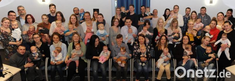 Bürgermeister Roger Hoffmann (hinten, Dritter von links) überreicht das Begrüßungsgeld.. Bild: gf