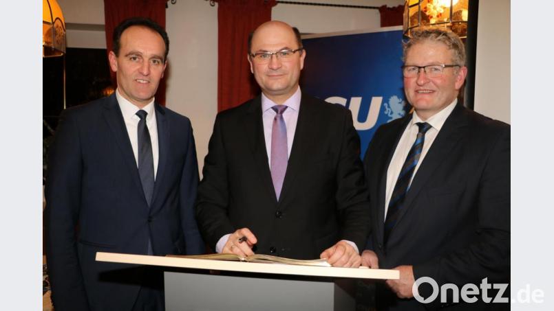 Das goldene Buch der Gemeinde Edelsfeld öffnet (von links) Bürgermeister Hans-Jürgen Strehl für den Eintrag des bayerischen Finanzministers Albert Füracker. Rechts im Bild CSU-Ortsverbandsvorsitzender Peter Mauritz.