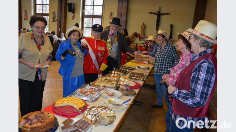 Sturm ans reichhaltige Buffet: 26 selbst gebackene Kuchen und Torten standen zur Auswahl. Anstellen mussten sich selbst Queen Elizabeth II. (Marianne Bauernfeind) und Prinz Philip (Herma Laumer) sowie Stadtpfarrer Anton Witt (hinten). Bild: jr