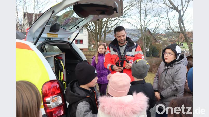 Ediz Kozanli von den HvO zeigt das Einsatz-Auto und einen Stecker: Das HvO-Auto wird immer angesteckt: Das Funkgerät läuft immer und muss geladen werden. Außerdem muss das Auto immer anspringen,, damit man schnellstmöglich beim Patienten ist. Bild: wrm