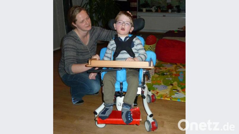 Simone Biebl schiebt ihren Sohn Ludwig im Therapiestuhl durchs Wohnzimmer. Die Familie strebt eine Behandlung in einer slowakischen Spezialklinik an, die es mit vielen „Internet-Klicks“ auch kostenfrei gäbe. Bild: Portner