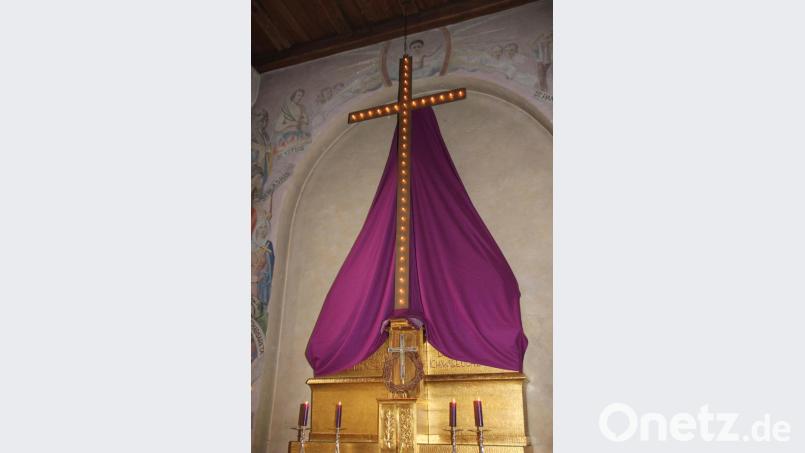 Mit 40 Glühbirnen für die 40 Fastentage ist das große Fastenkreuz in der Barbarakirche versehen. Nach 30 Jahren hängt es heuer erstmals wieder vor dem verhüllten Altar in der Kirche auf der Luitpoldhöhe, nachdem es restauriert wurde. Bild: ads