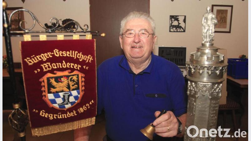 Stolz zeigt Vorsitzender Georg Hottner die Standarte der Bürgergesellschaft Wanderer und den Zinnpokal, in den die Namen der Gründungsmitglieder eingraviert sind. Bild: Hirsch