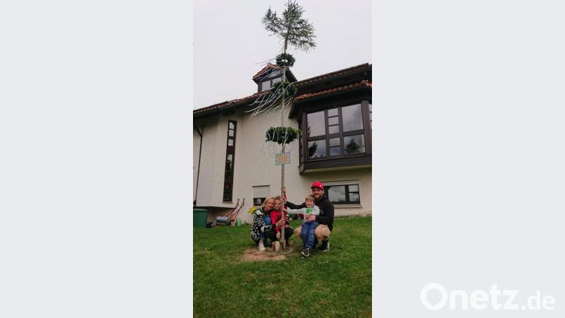 Franziska und Marvin Seitz zusammen mit den Jungs Marlon und Lennon am Maibaum im Garten der Familie. Bild: exb