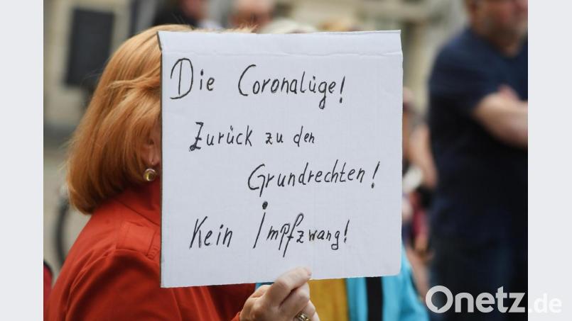 Auf einer Demonstration gegen die Maßnahmen zur Eindämmung der Corona-Pandemie hält eine Frau ein Schild mit dem Schriftzug &quot;Die Coronalüge! Zurück zu den Grundrechten! Kein Impfzwang!&quot; hoch. Bild: Stefan Sauer/dpa