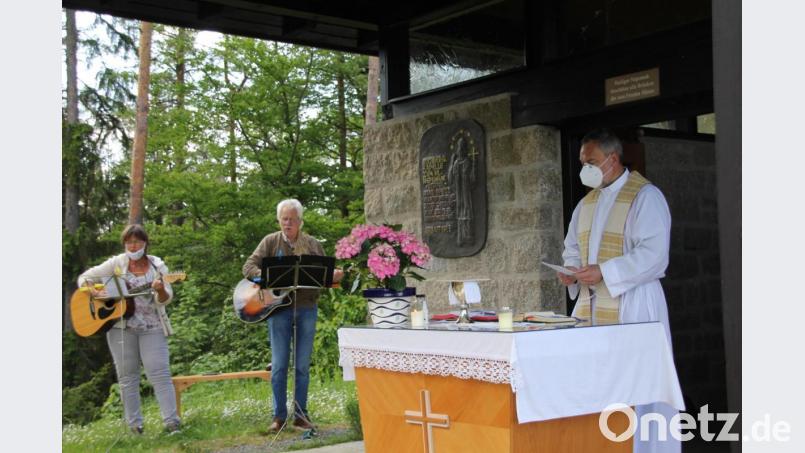 Pfarrer Josef Irlbacher beim Gottesdienst zum Patrozinium an der Nepomuk-Kapelle auf dem Buchberg. Musikalisch begleiteten ihn der Vorsitzende des Kapellenvereins, Hans Weiß, und dessen Frau Sabine, die ein „Nepomuklied“ geschrieben hat, das beim Patrozinium Uraufführung hatte. Bild: ads