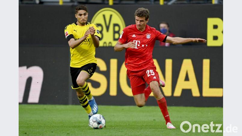 Dortmunds Achraf Hakimi und Münchens Thomas Müller (l-r.) in Aktion. Foto: Federico Gambarini/dpa-Pool/dpa Bild: Federico Gambarini